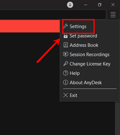 ภาพสกรีนช็อตแสดงวิธีการคลิกเมนู Dropdown มุมขวาบนเพื่อเลือกเมนู Settings ในโปรแกรม AnyDesk ซึ่งเป็นขั้นตอนแรกของการตั้งค่ารีโมทคอมพิวเตอร์แบบไม่ต้องกด Accept